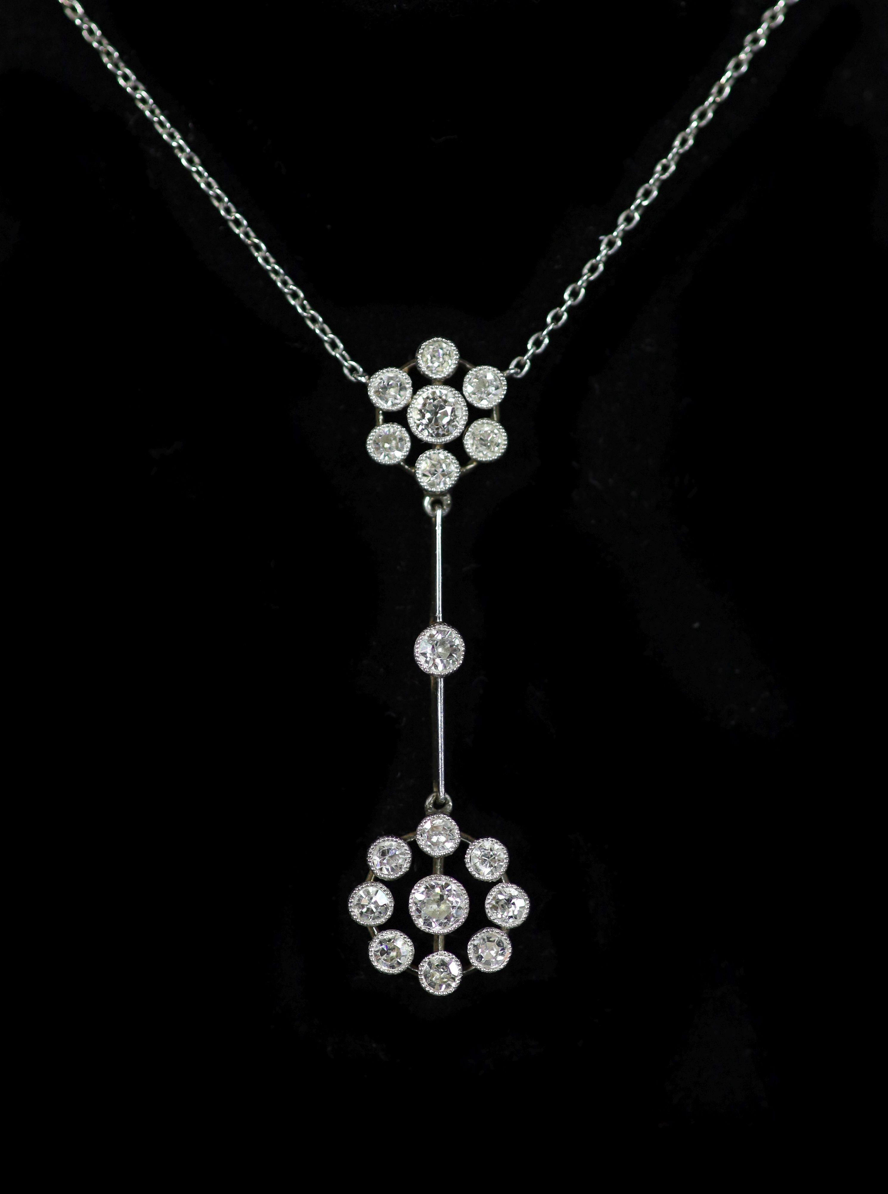 An early 20th century gold, platinum and millegrain set old round cut diamond double cluster drop pendant necklace